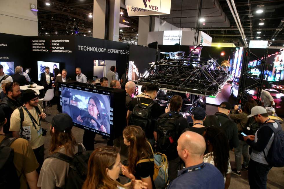 A conventioneer checks out an "enhanced environment" inside a car in the production e ...