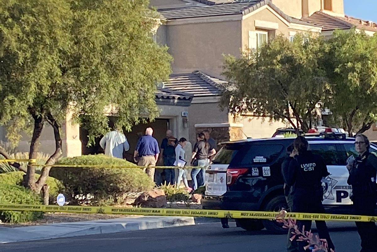 Las Vegas police officers investigate a homicide in the 8800 block of Canyon Saddle Drive in th ...