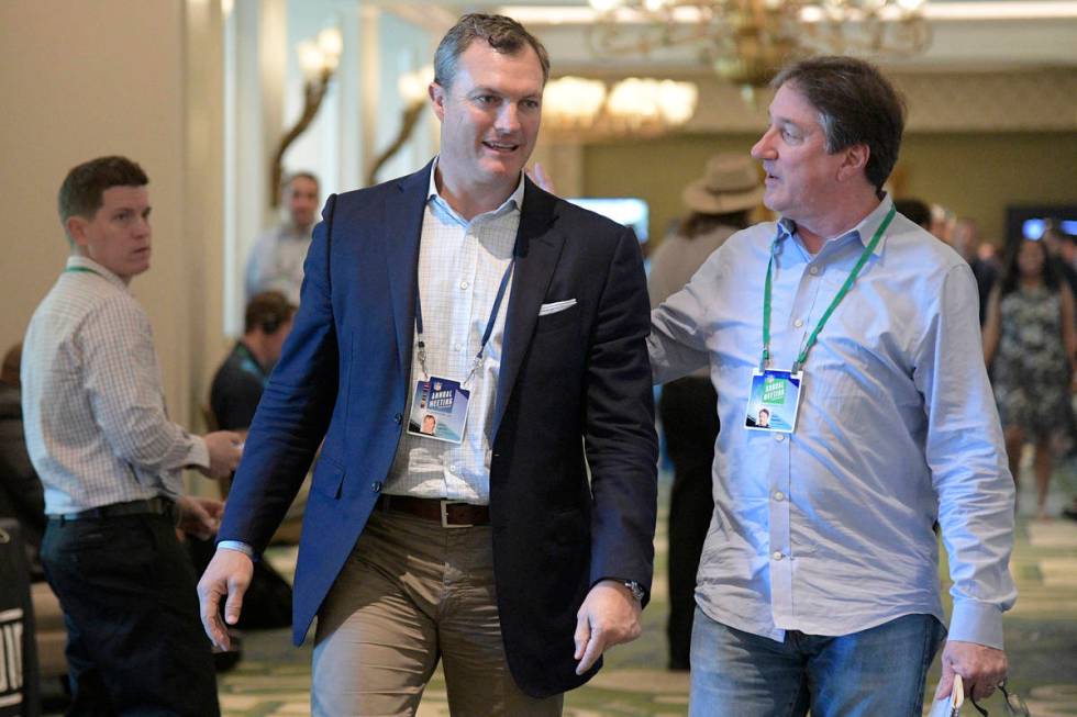 San Francisco 49ers general manager John Lynch chats with Don Banks, right, while walking to a ...