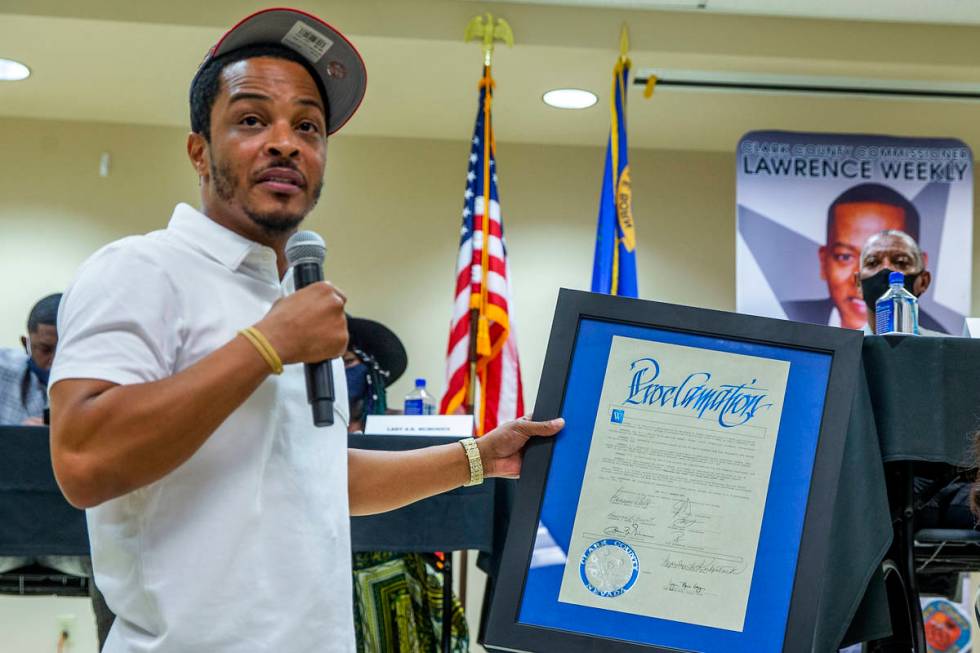 Rapper and entrepreneur Tip T.I. Harris, left, accepts a proclamation granting him today his da ...