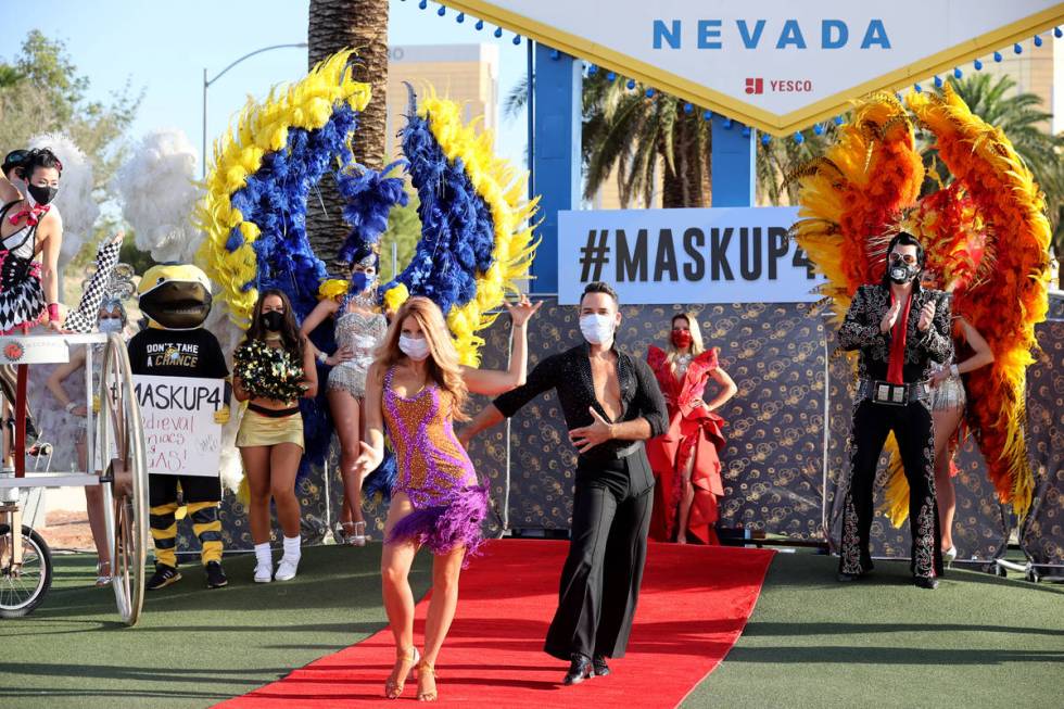 Ballroom dancers Sarah LeClear and husband Alejandro Domingo "walk" the red carpet at ...