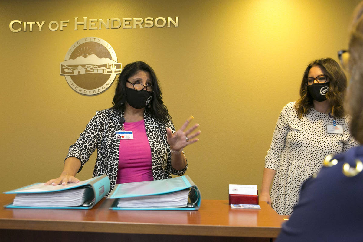 Sabrina Mercadante, the City of Henderson clerk, speaks to Laura Sanchez, right, after receivi ...