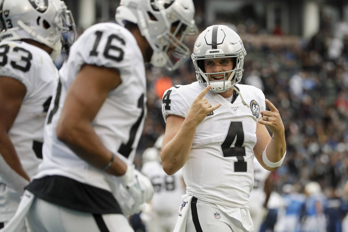 Oakland Raiders quarterback Derek Carr celebrates after a touchdown by running back DeAndre Was ...