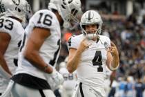 Oakland Raiders quarterback Derek Carr celebrates after a touchdown by running back DeAndre Was ...