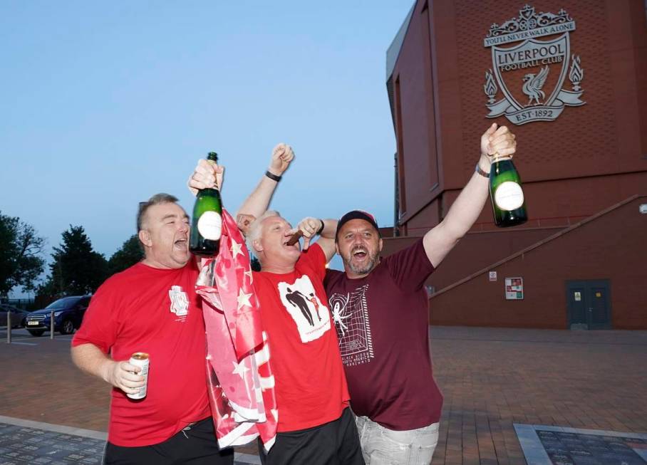 Liverpool supporters celebrate outside Anfield Stadium in Liverpool, England, Thursday, June 25 ...