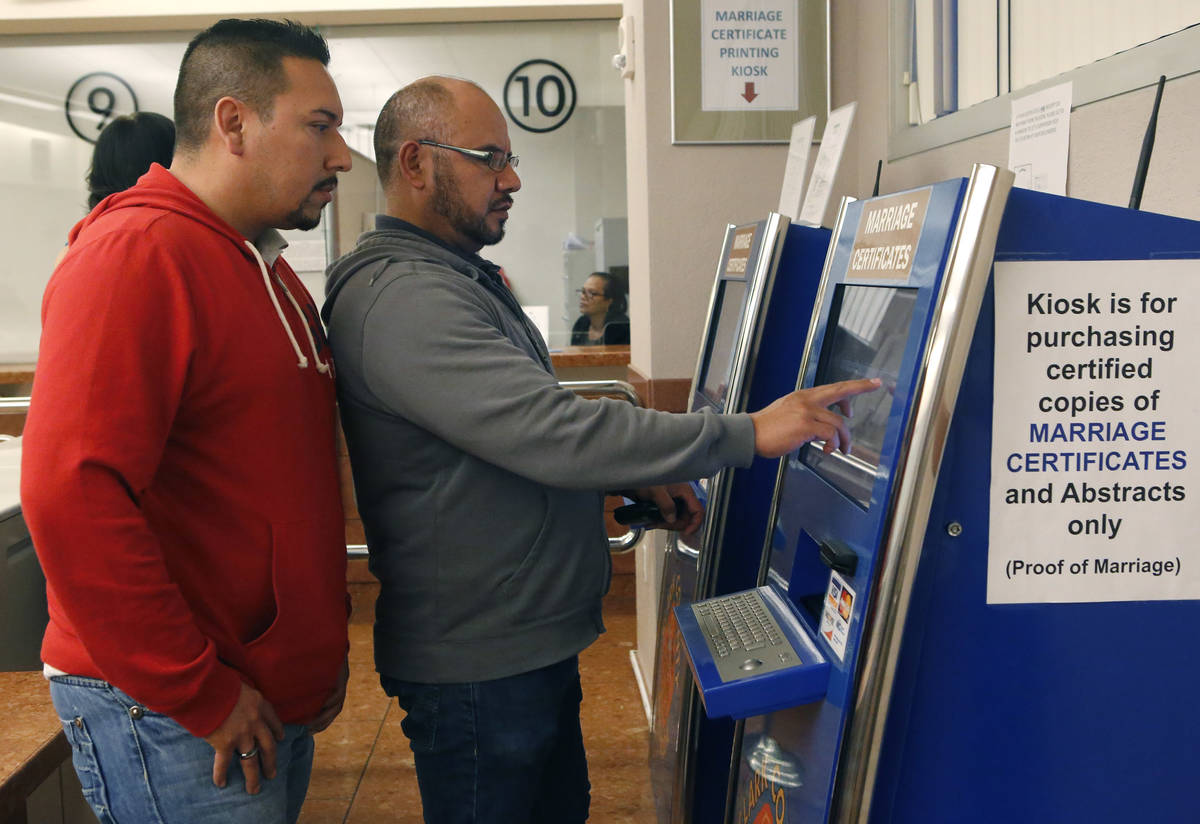 Raul Luna, 37, left, and Luis Zamarripa, 49, right, purchases their marriage certificate at th ...