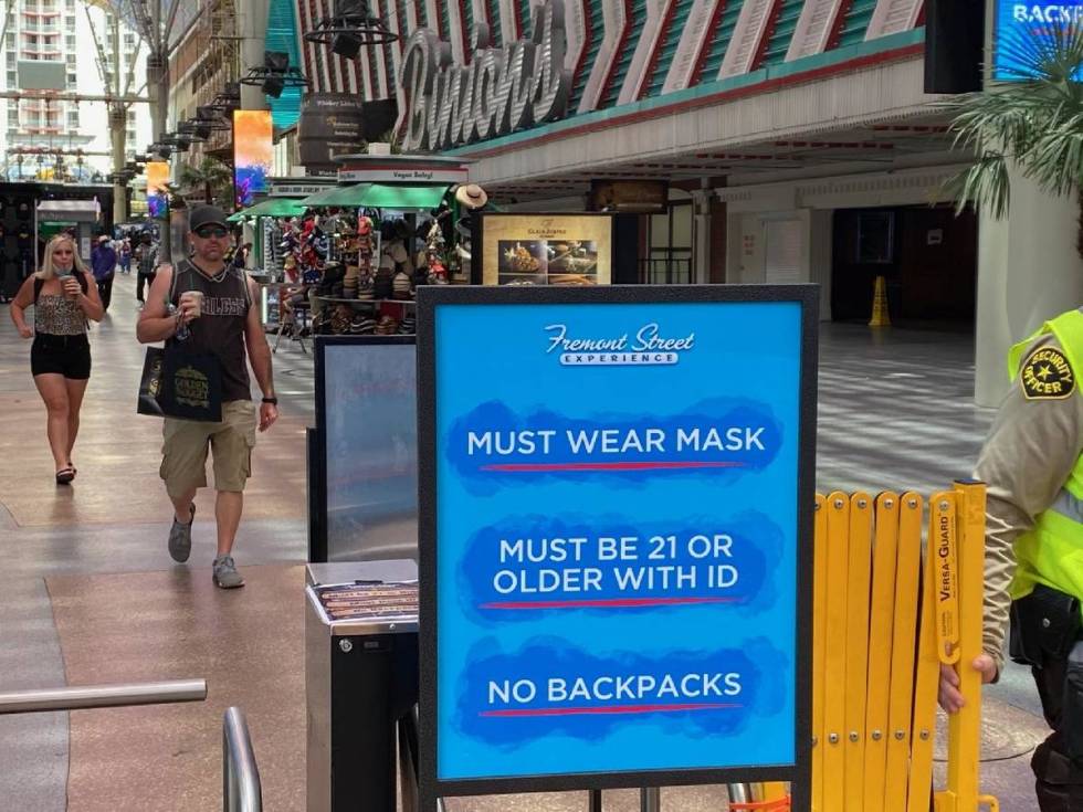 A sign at Fremont Street Experience in downtown Las Vegas reminds guests that masks are require ...