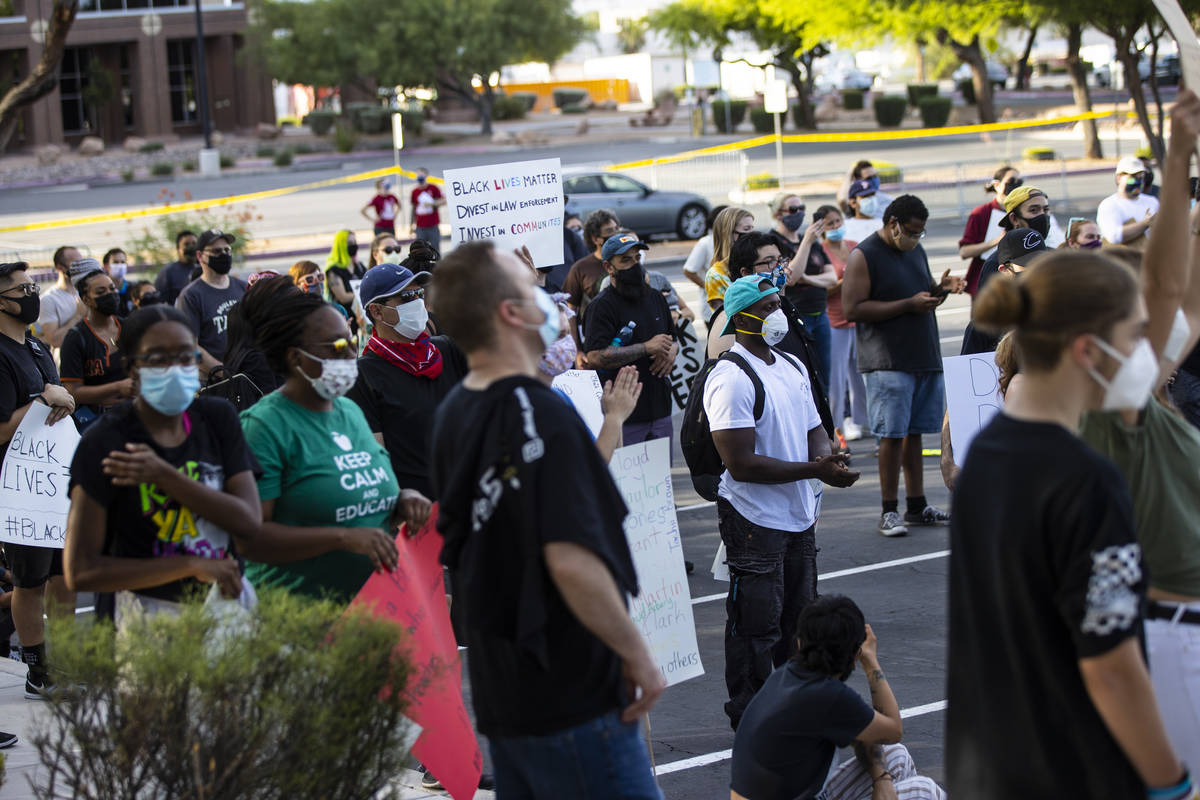 People listen as Minister Vance "Stretch" Sanders, not pictured, speaks during a Black Lives Ma ...