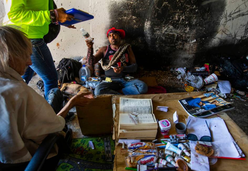 Dwain Butler II, foreground, and Victor Shelton, right, are contacted by HELP of Southern Nevad ...