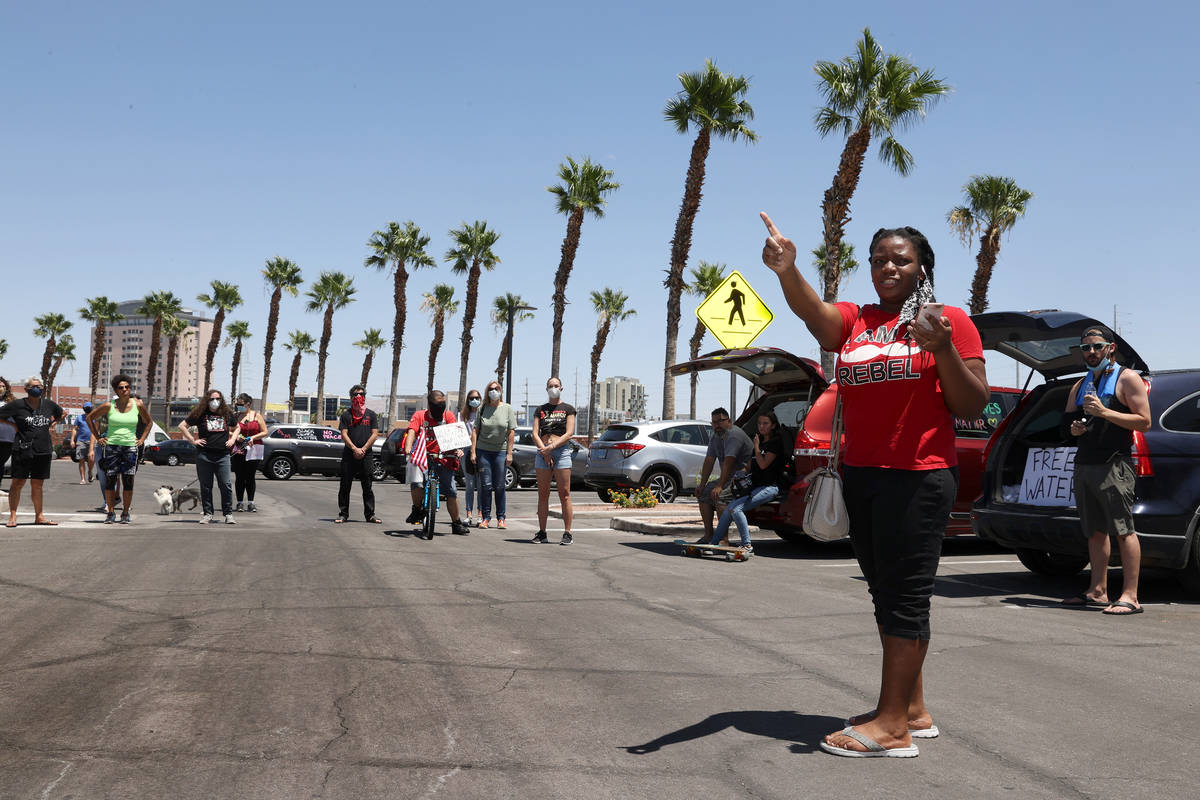 Tia Coward, event organizer and Las Vegas resident, gives instructions to people in advance of ...