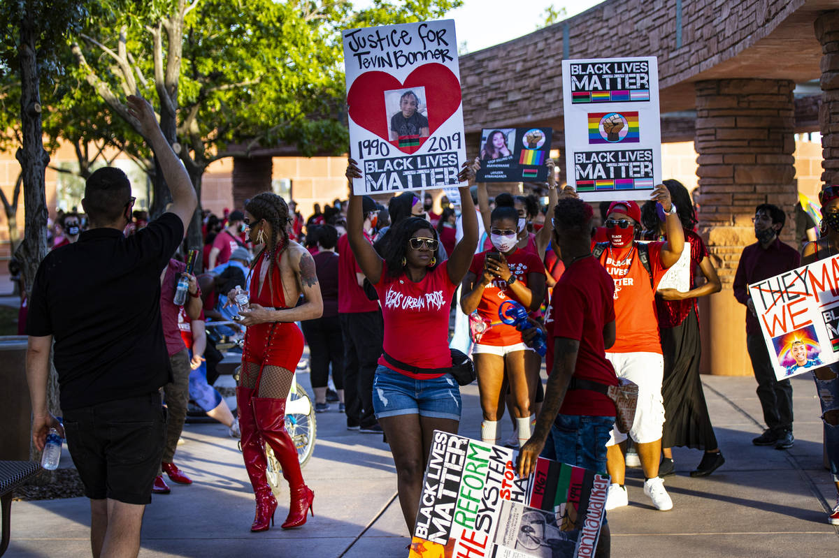 Event organizer Nicole Williams, center, helps lead a silent solidarity march in support of Bla ...