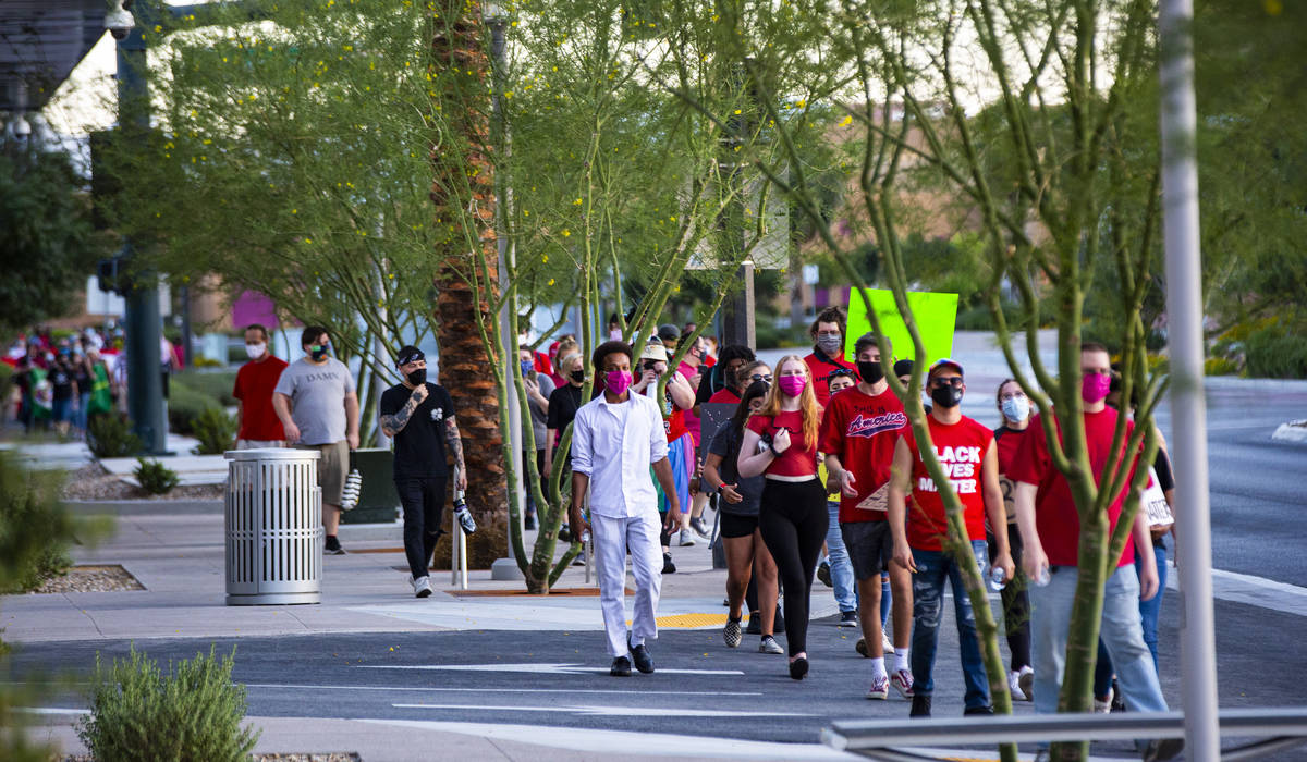 People participate in a silent solidarity march in support of Black Lives Matter and the Stonew ...