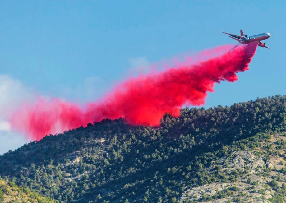 An air tanker drops fire retardant while fighting the Mahogany Fire on Mount Charleston on Mon ...