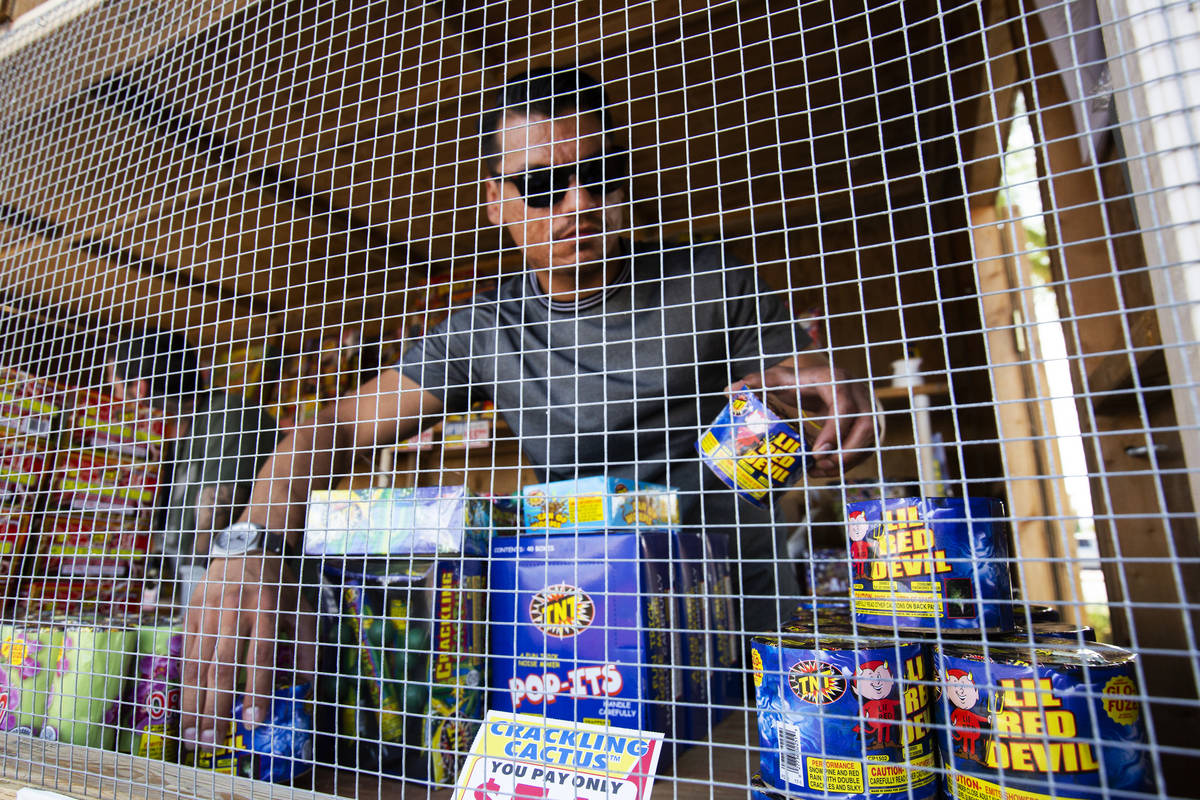 Floyd Ellis organizes fireworks at the front of the fireworks booth for Freedom House Sober Liv ...