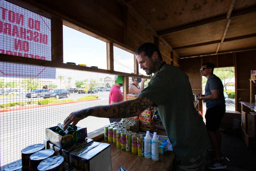 Jeremiah Wicker and Floyd Ellis gather fireworks for customers in the booth for Freedom House S ...