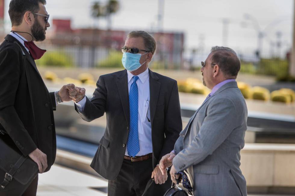 Attorney Andrew Marcantel, left, greets Douglas Haig with attorney Marc Victor as they arrive f ...