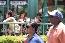 Tourists enjoy their meals in the outdoor dinning area at Mon Ami Gabi restaurant on Sunday, Ju ...