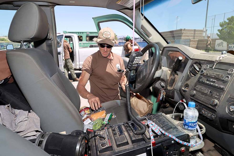 Adam Jarkow of the Truckee (Calif.) Hotshots checks his lunch on Tuesday, June 30, 2020, at Cen ...