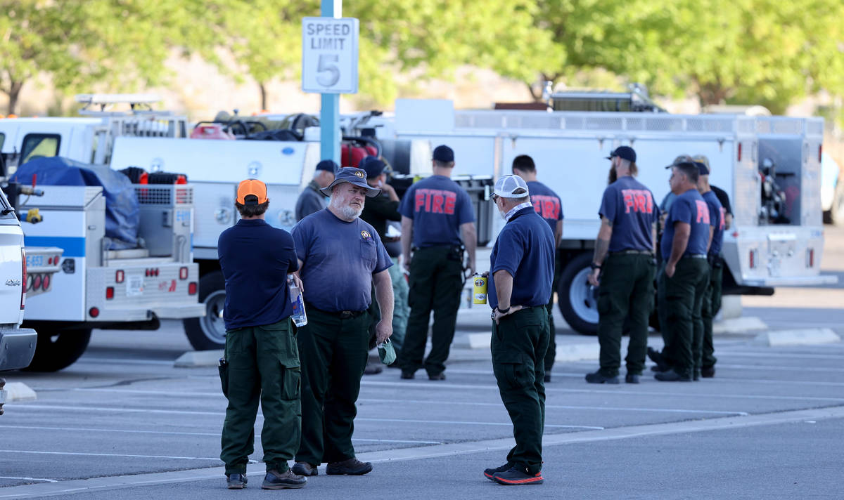 Firefighters from different agencies gather at Centennial High School in Las Vegas as they prep ...