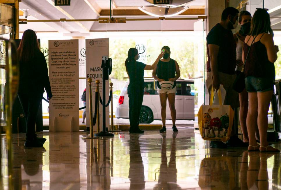 A man stops stop for a temperature check at tthe Westgate in Las Vegas on Saturday, June 27, 20 ...