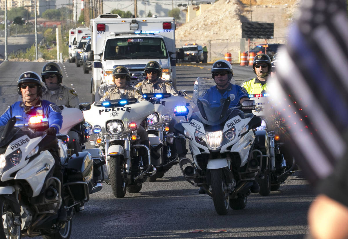 An ambulance carrying wounded Las Vegas police officer Shay Mikalonis is seen during a processi ...