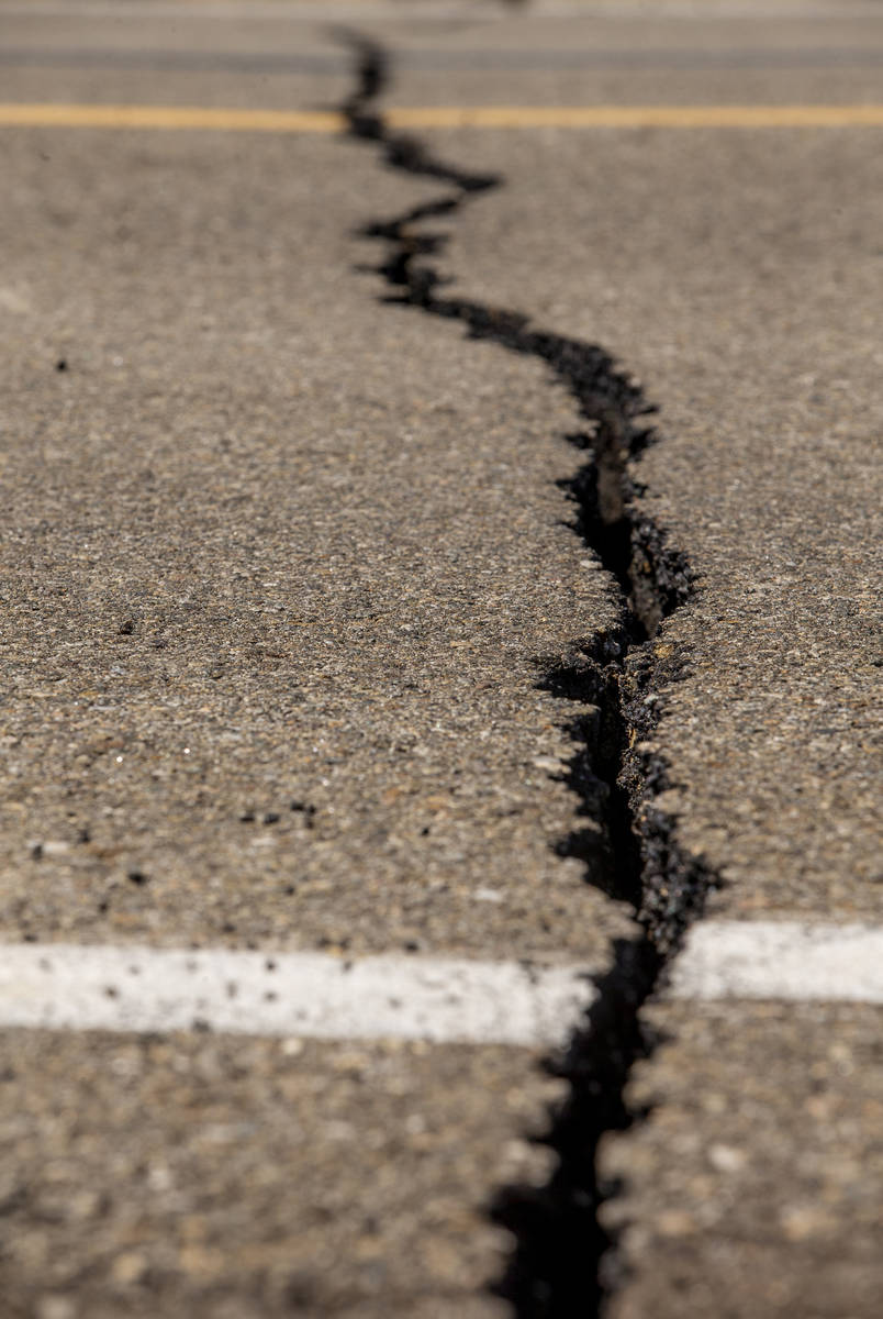 Caltrans workers continue to monitor the extensive cracks with shifting pavement that have open ...