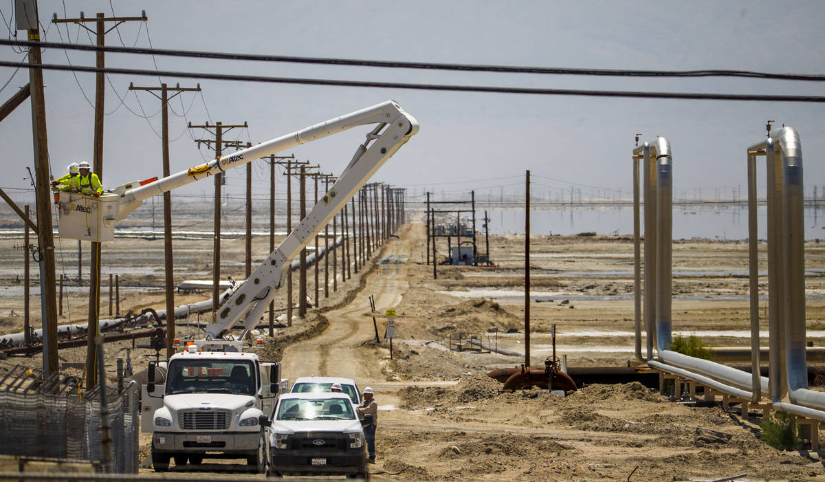 A Southern California Edison crew works to repair the power lines near the Searles Valley Miner ...