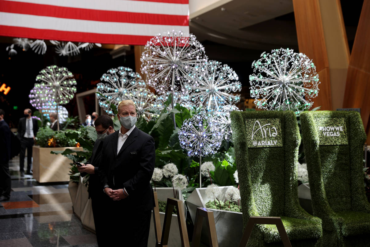 Employees with the summer lobby display ”Dandelion Forest” at Aria on the Strip in Las Vega ...