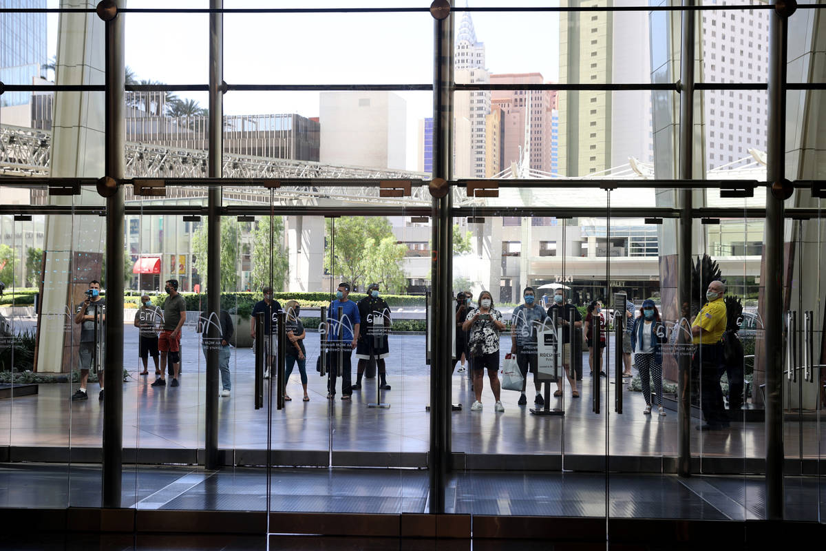 Guests wait outside Aria on the Strip in Las Vegas before reopening Wednesday, July 1, 2020. (K ...