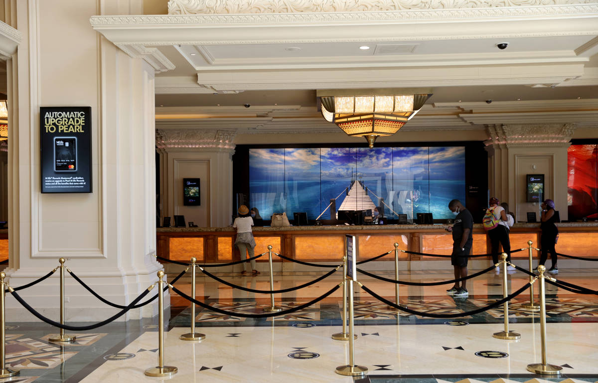 Guests check in Mandalay Bay on the Strip in Las Vegas upon reopening Wednesday, July 1, 2020. ...