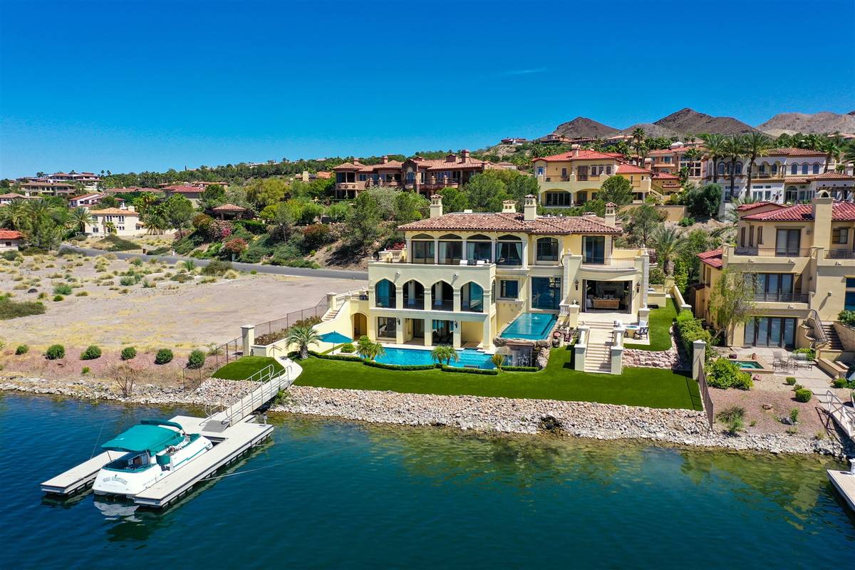 The three-level home has a two-level pool and boat dock. (Luxurious Real Estate)