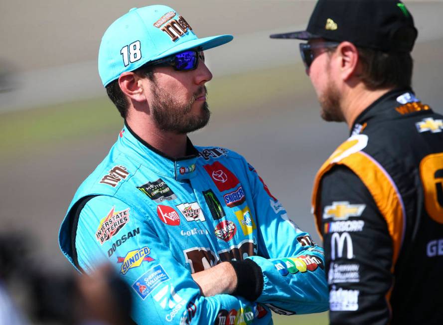 Kyle Busch, left, talks with Kurt Busch before qualifying for the Monster Energy NASCAR Cup Ser ...