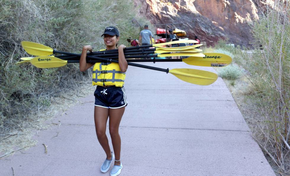 Ashia Paez of New York prepares for a day of kayaking in Black Canyon at the base of the Hoover ...