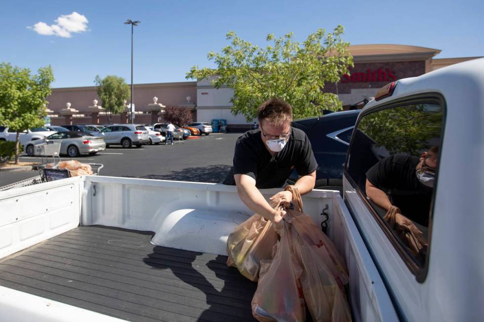 Mason Stanley unloads groceries from the Smith's Food & Drug on West Charleston Boulevard a ...