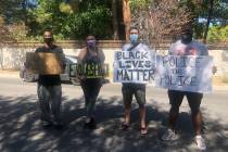 Kenny Fawkes and Sam McKellar, standing to the left, pose with other protesters in Las Vegas Ma ...
