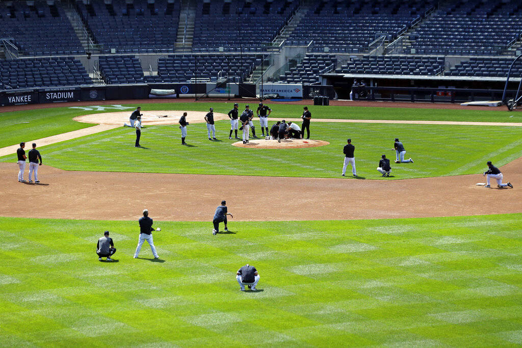 The New York Yankees team reacts after pitcher Masahiro Tanaka was hit in the head by a basebal ...