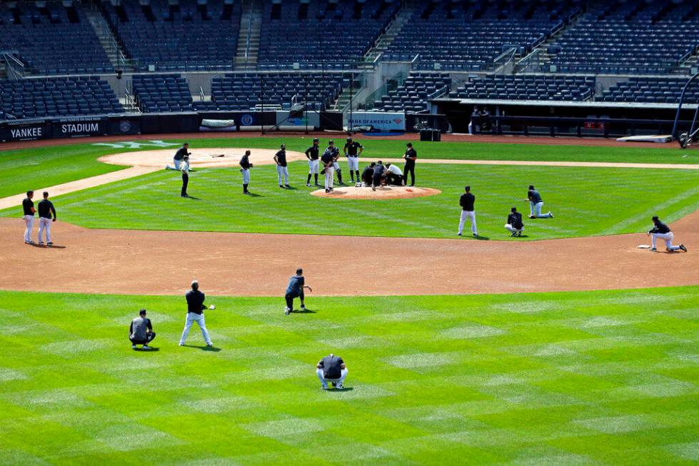 The New York Yankees team reacts after pitcher Masahiro Tanaka was hit in the head by a basebal ...