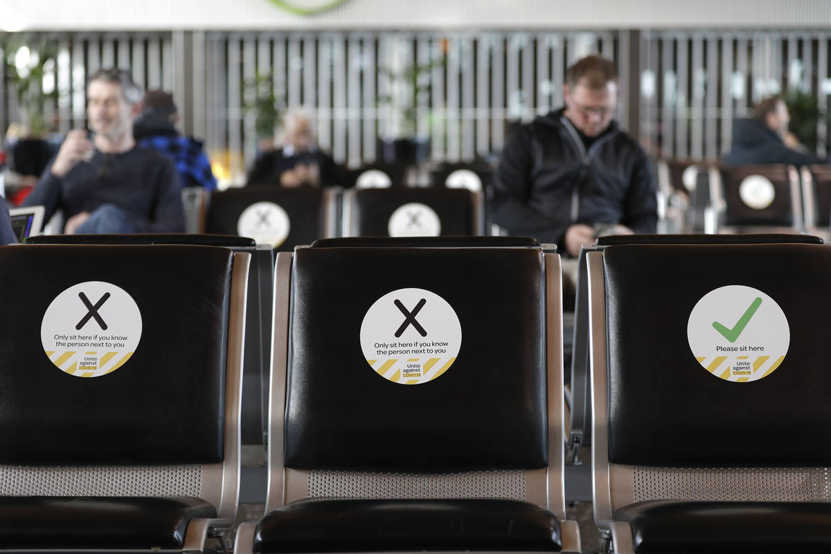 FILE - In this May 14, 2020, file photo, passengers wait to board their flight at Christchurch ...