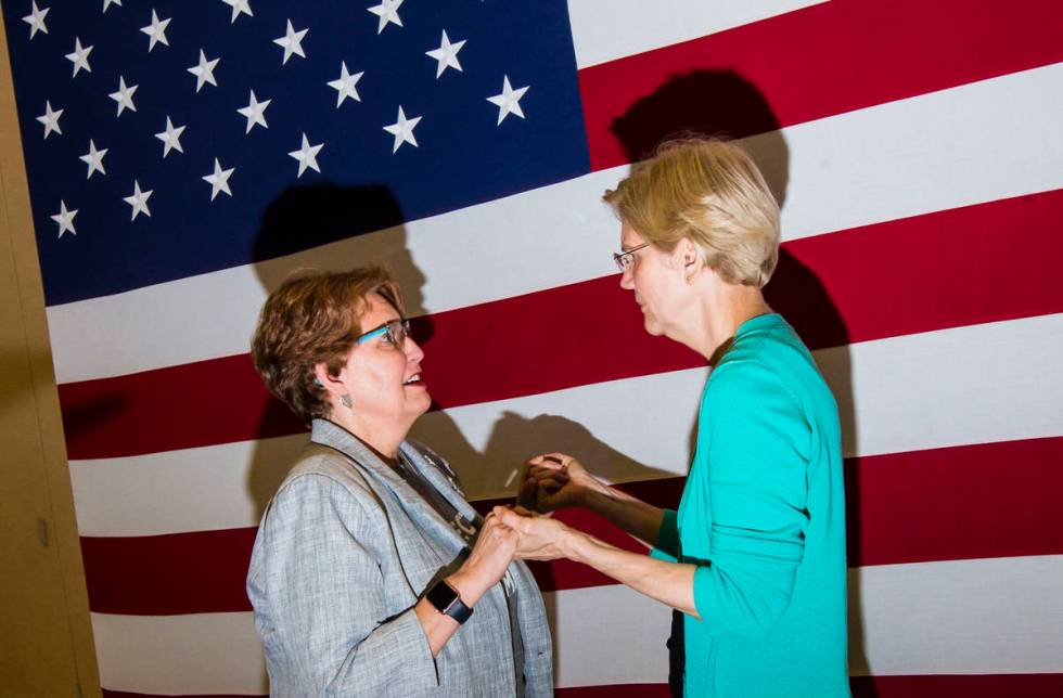 Donna West, chair of the Clark County Democratic Party, left, talks with Democratic presidentia ...