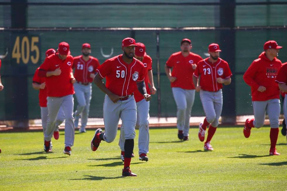 In this Feb. 17, 2020, file photo, Cincinnati Reds relief pitcher Amir Garrett leads other pitc ...