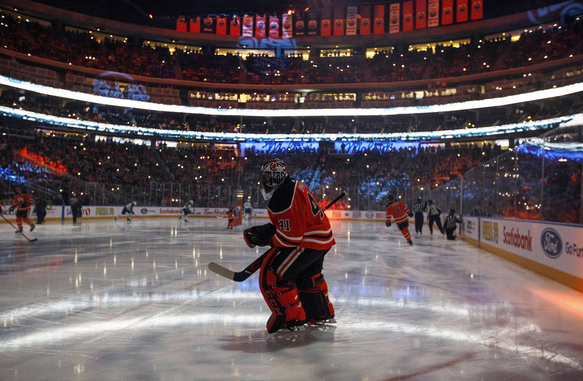 In this Feb. 20, 2020, file photo, Edmonton Oilers goalie Mike Smith warms up for the team's NH ...