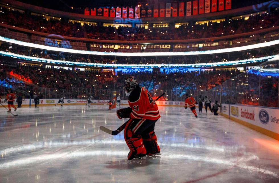 In this Feb. 20, 2020, file photo, Edmonton Oilers goalie Mike Smith warms up for the team's NH ...