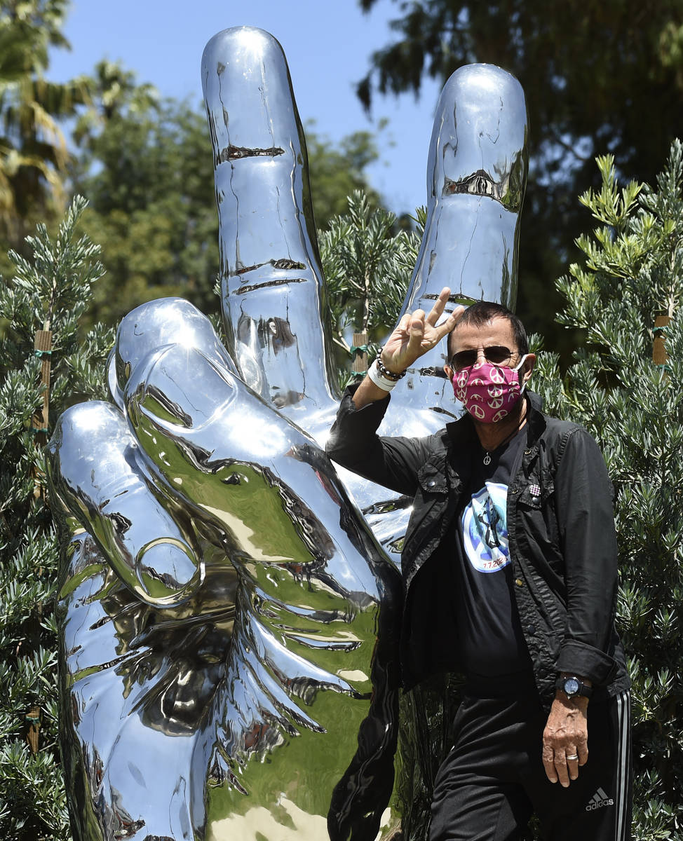 Musician Ringo Starr poses in front of his "Peace and Love" public sculpture on his 8 ...