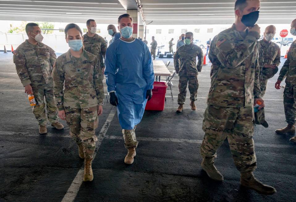 Nevada National Guardsmen take part in a preview of the new drive-thru COVID-19 testing site in ...