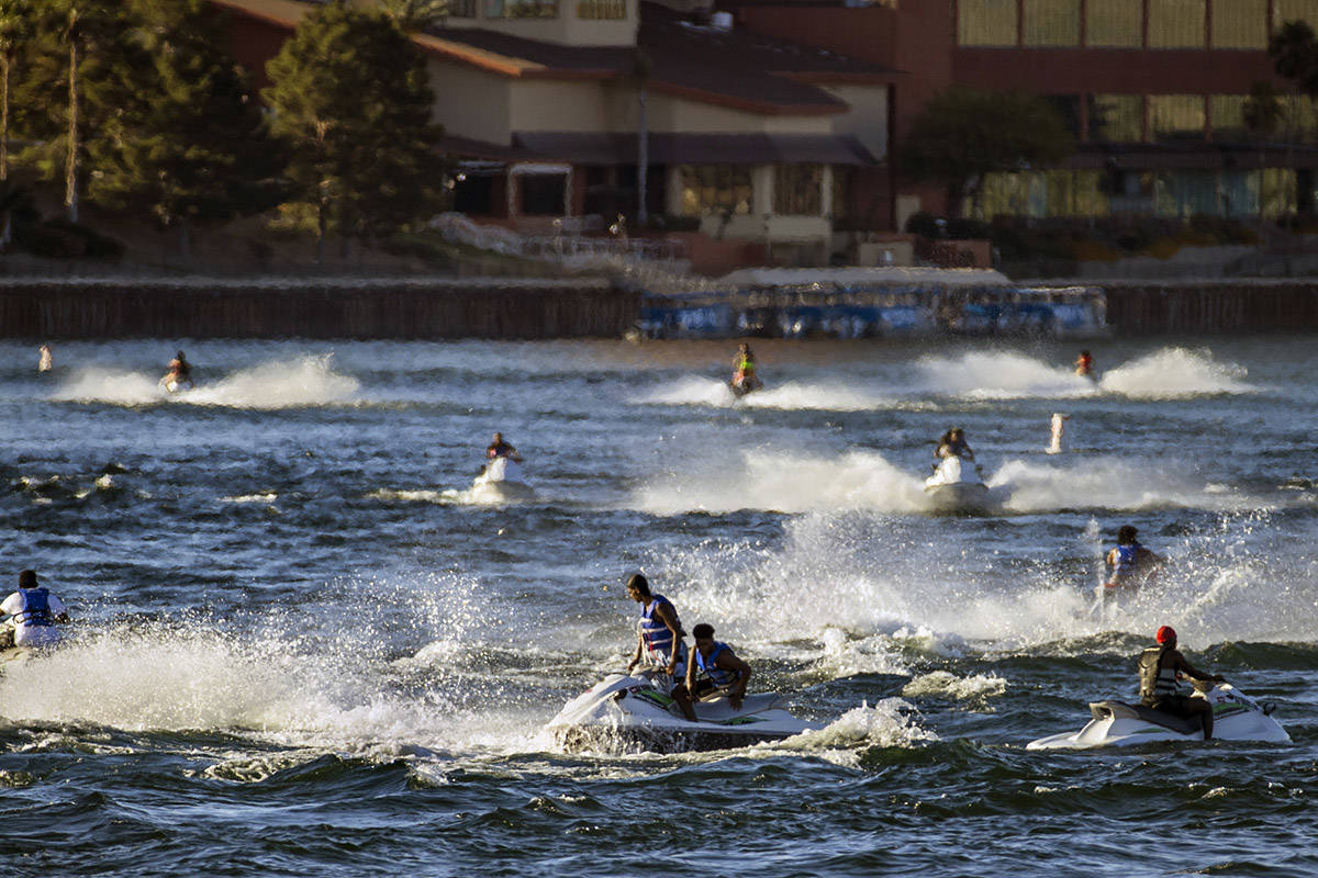 Jetskiers cruise across along the Colorado River about the Bullhead City Community Park during ...