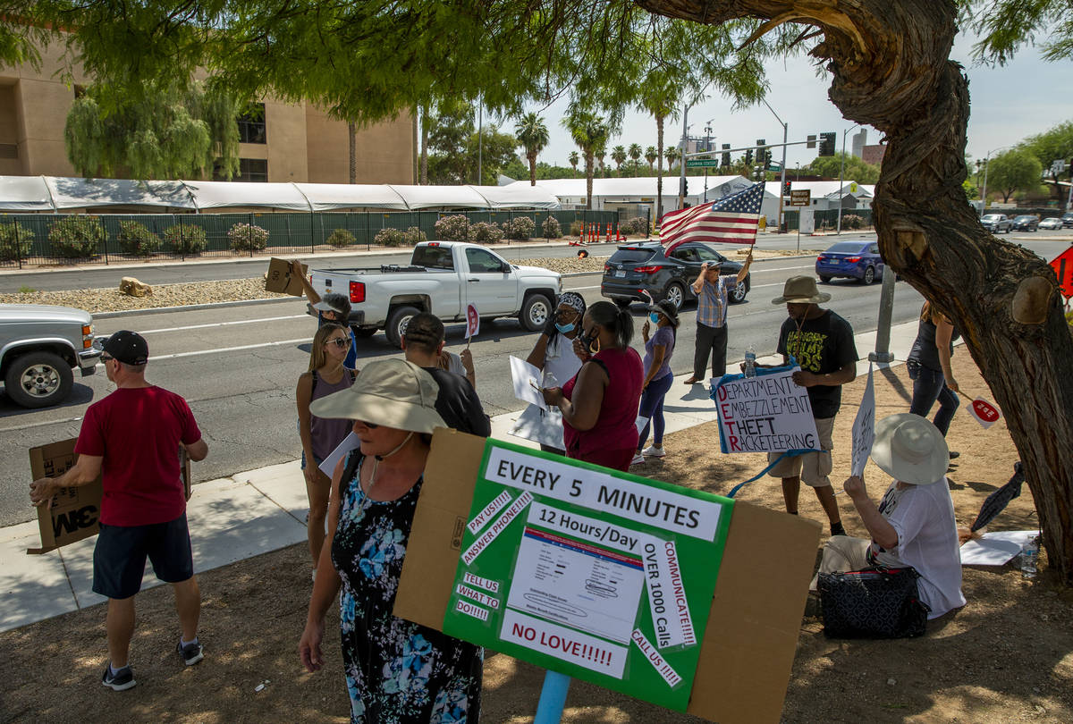 Gig workers gather with signs wave to passing motorists along E. Washington Ave. to protest the ...