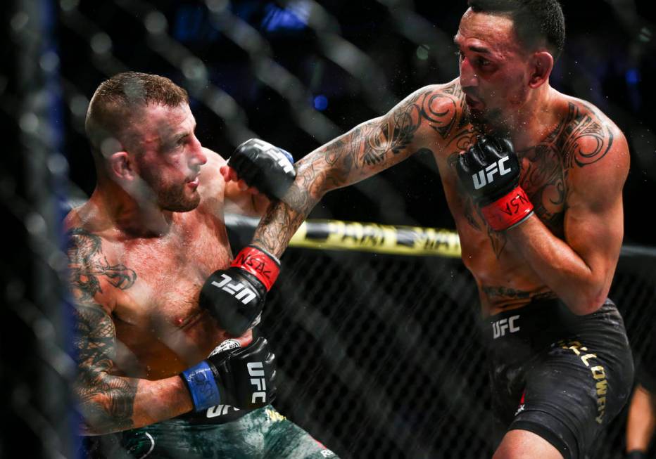 Alexander Volkanovski, left, fights Max Holloway during their featherweight title boutÊin ...