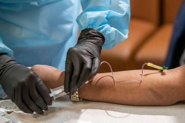 A registered nurse draws blood from Harlem resident Saundra Maynard during a COVID-19 antibody ...