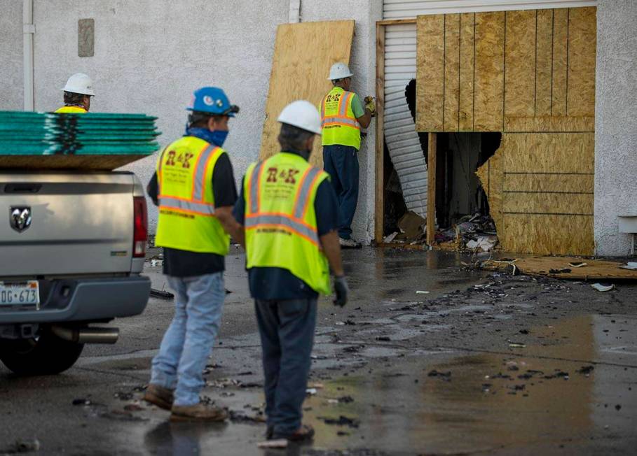 Crews from R & K Concrete Cutting Inc. secure the building after an early morning a two-ala ...