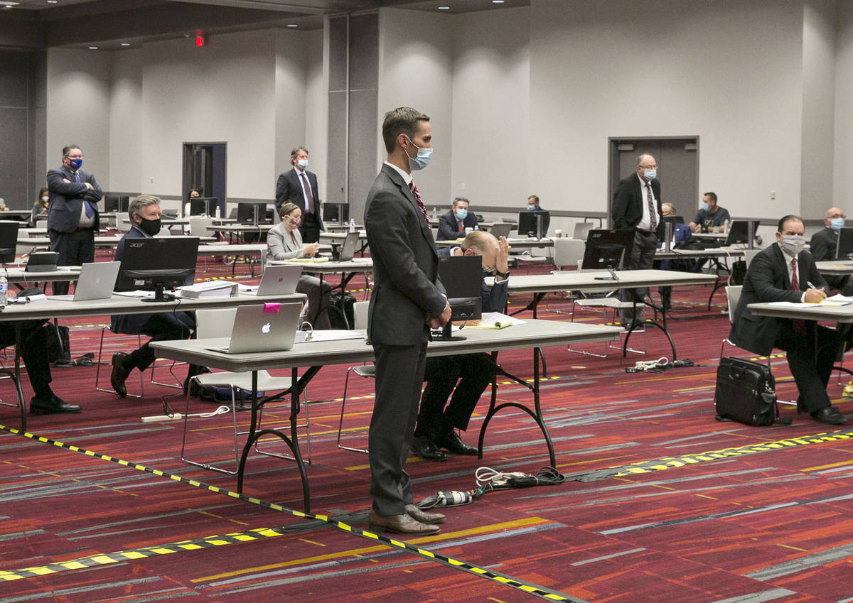 Attorneys, including Jordan Smith, center, representing Essence dispensary, are seen during a p ...